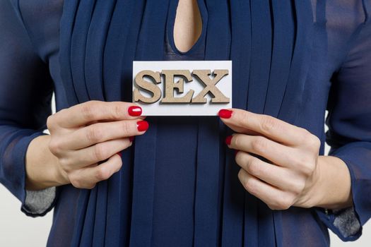 Card with the word Sex in the female hands.