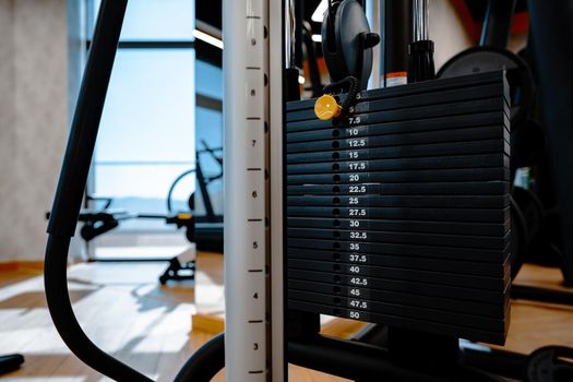 Stacked iron plates of weight machine in a gym