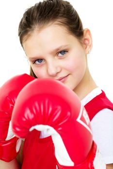 Smiling girl training in boxing gloves. Portrait of teenage girl boxer dressed sportswear ready to fight. Child posing on isolated white background. Healthy lifestyle, sport and fitness concept