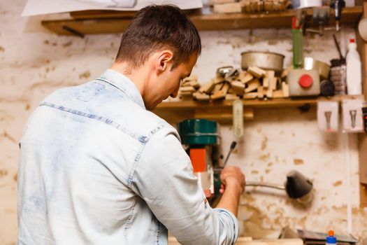 Carpenter works in a workshop for the production of vintage furniture