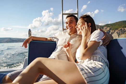 Happy couple in love on a yacht in summer on romantic vacation