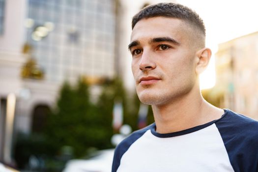 Portrait of handsome young casual man walking on the city street