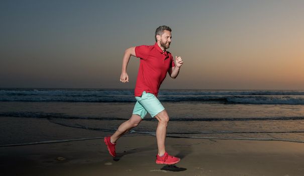 sportsman sprinter running on sunrise summer beach at ocean, athlete.