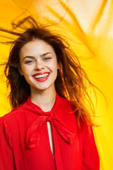 cheerful woman in red dress makeup yellow cloth posing. High quality photo