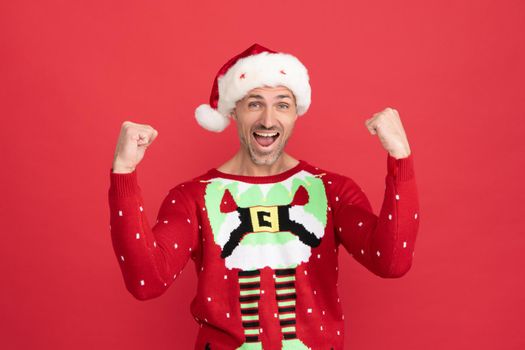 Winner announced. Happy santa claus man. Christmas elf scream making winning gesture. Merry Christmas. Happy new year. Share happiness.