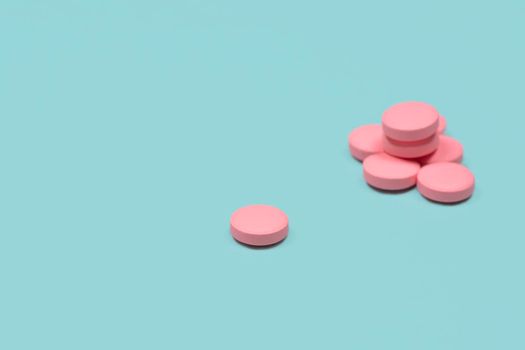 Medical background with pills. Pink Pills on blue or mint background. Macro photo. Copy space