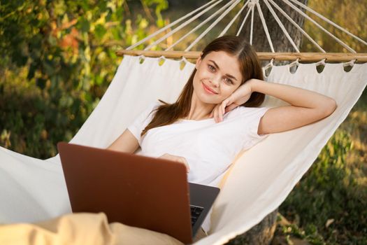 woman love with laptop on nature vacation work travel. High quality photo