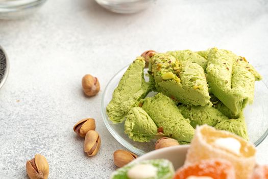 Close up photo of colorful Turkish halva sweets on gray surface