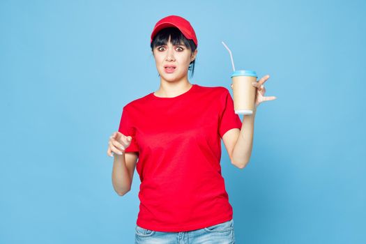 woman in red uniform cup of coffee blue background fun. High quality photo