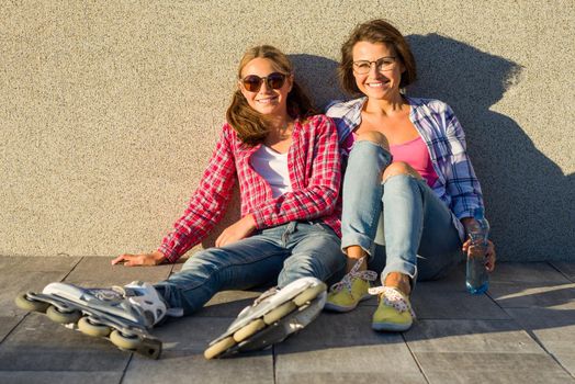 People, motherhood, family, summer. - Happy mother and daughter talking outdoors