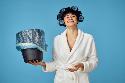 Woman in white robe housework cleaning service blue background. High quality photo