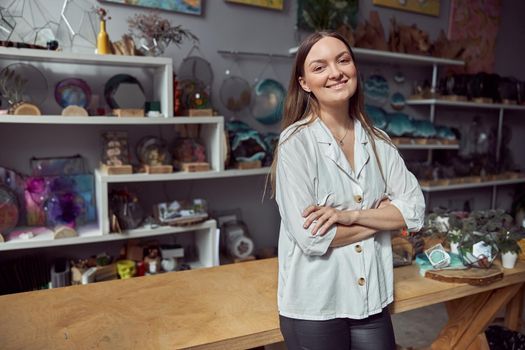 Young caucasian happy seller woman at botanic shop