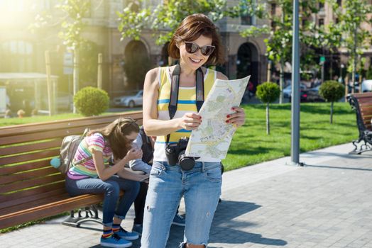 Happy woman tourist travel holding camera and map