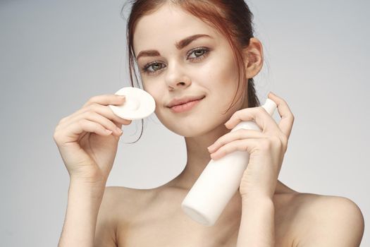 woman with bare shoulders cosmetics procedures skin care cream. High quality photo