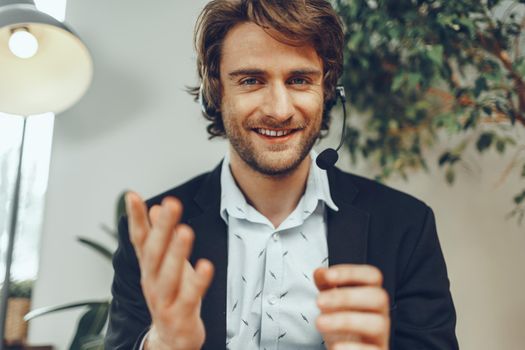 Bearded man businessman with headset having online business conversation close up