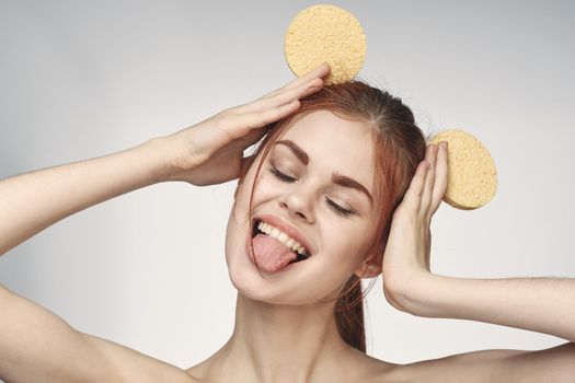 woman yellow sponge clean skin hygiene light background. High quality photo