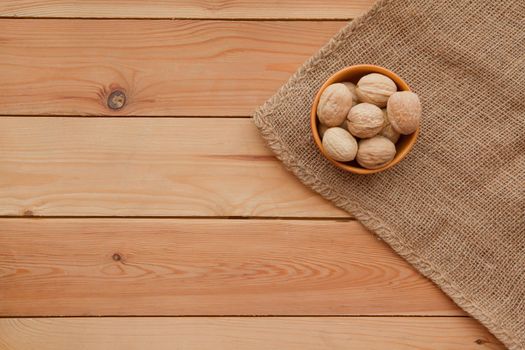 Tasty wallnuts on a wooden table on a plate. flat lay rustic image