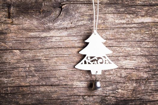 Christmas decorations - white wooden fir tree over shappy old background