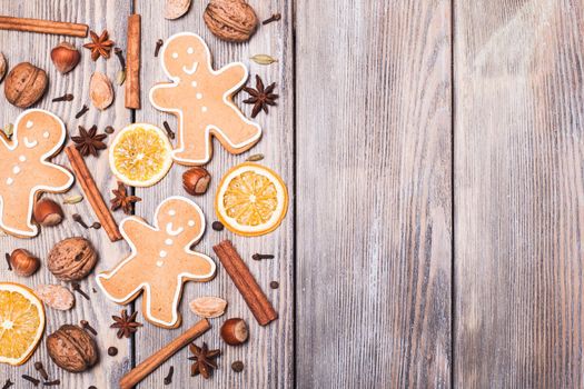 Gingerbreads with spices on the wooden table. Christmas aroma decor