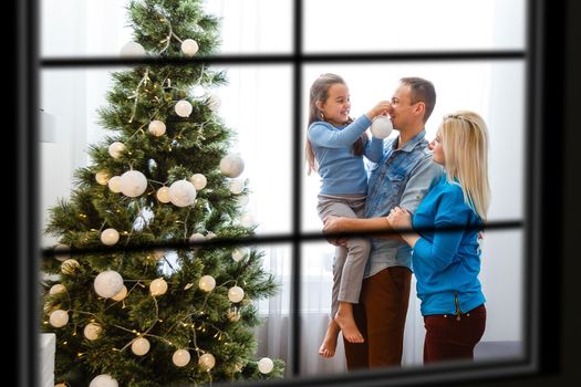 wiew through the window, Christmas Tree on background, winter holiday concept