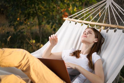 woman lies in the corner with laptop vacation nature technology. High quality photo