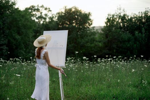 pretty woman in white dress outdoors drawing art creative. High quality photo