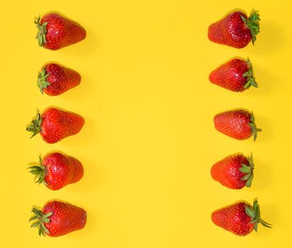 Fresh Strawberries close up. Strawberries isolated on bright yellow background with free space. Frame, template or mock up. Flat lay.