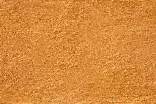 Colorful concrete wall, bright warm yellow vintage style of cement background paint with small texture details. old texture surface