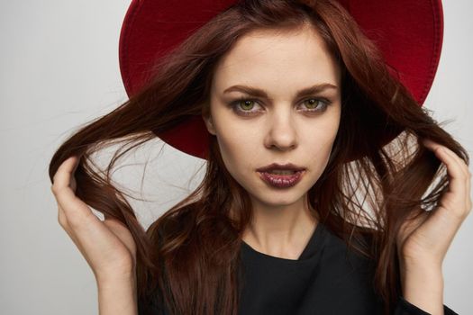 woman in a red hat black lipstick emotions witch. High quality photo