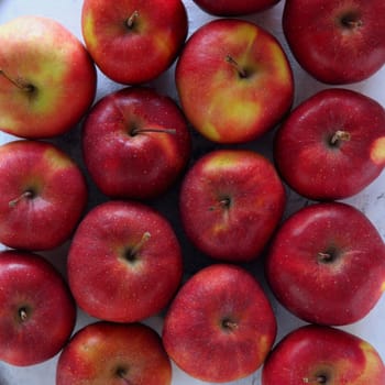 Gyration red ripe apples close-up. From above shot of tasty red apples flat lay