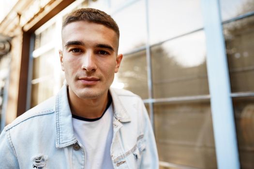 Portrait of handsome young casual man walking on the city street