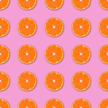 Fresh orange tangerine slices seamless pattern. Close up of citrus fruit on pink background. Studio photography.