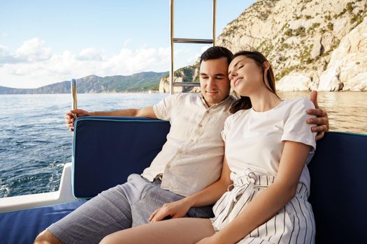 Happy couple in love on a yacht in summer on romantic vacation