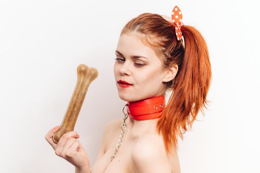 pretty woman with leash around her neck dog bone costume posing. High quality photo