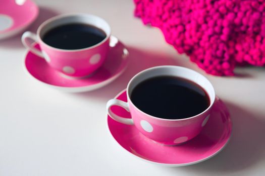 pink flowers on the table - Two pink coffee cups on white background, coffee break and caffeine addiction concept. vintage design and retro style