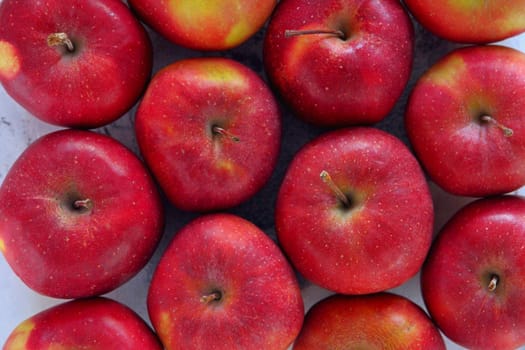 Gyration red ripe apples close-up. From above shot of tasty red apples flat lay