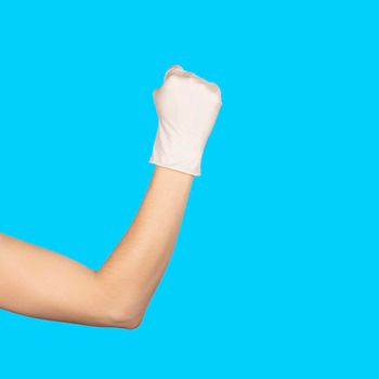 Hand gesture. Hand in a white latex glove showing Solid fist or anger gesture isolated blue, background. Sign isolated on white background. Copy space