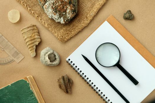 Stone samples, loop, notebook at geological laboratory. Geology rock laboratory. Laboratory for analysis of geological soil materials, stones, minerals, rocks samples for researchers- Brushing samples.