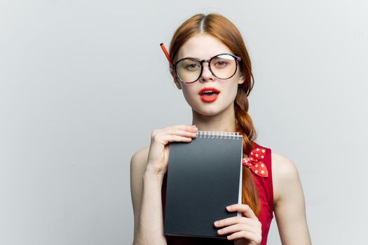 Business woman in red dress notebook pencil professionals. High quality photo