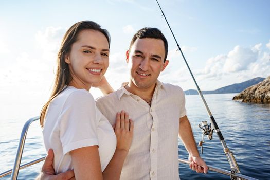 Happy couple in love on a yacht in summer on romantic vacation