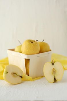 yellow apples at the basket on white background - Symbolic image. Concept for healthy nutrition. Front view.