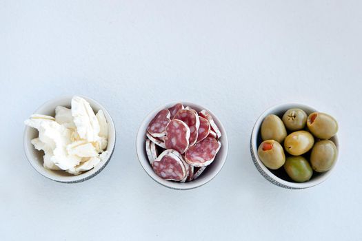 Antipasto catering platter with different meat and cheese products. cheese, olives and meat for a simple breakfast