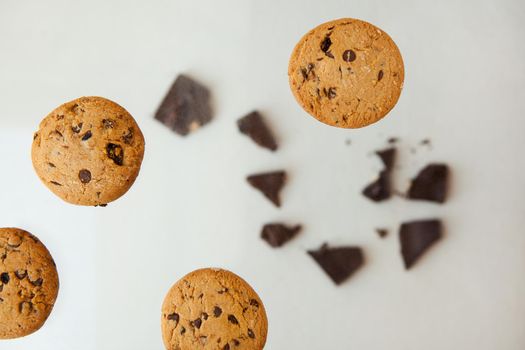 Homemade bakery and dessert. chocolate cookies flying - Chocolate chip cookie with crumbs on gray background.