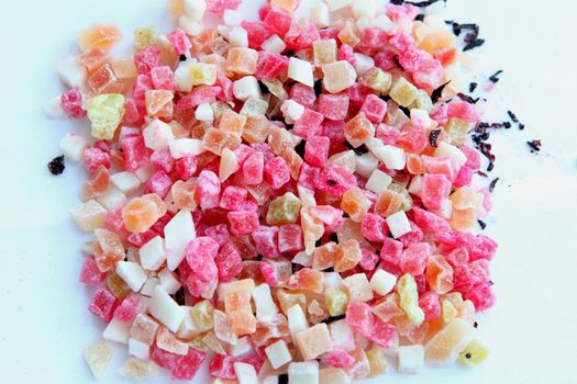 colorful fruit tea cubes pieces - dried fruits. fruit mixed tea contains slices of an apple, slices of pineapple, banana, berries buckthorn, raspberry and papaya