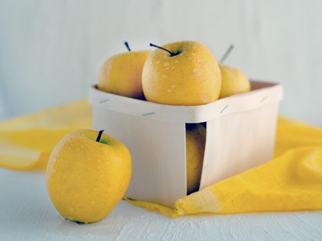 yellow apples at the basket on white background - Symbolic image. Concept for healthy nutrition. Front view.