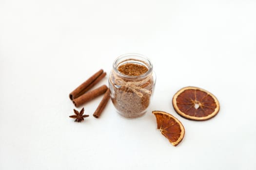 Cinnamon sticks and star anise on brown sugar with shallow depth of field on white background. Baking ingredients for cooking