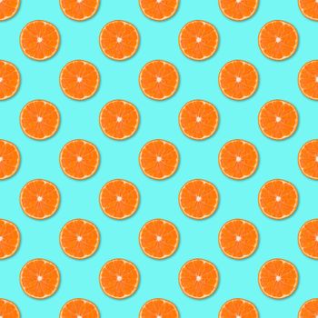 Fresh orange tangerine slices seamless pattern. Close up of citrus fruit on blue background. Studio photography.