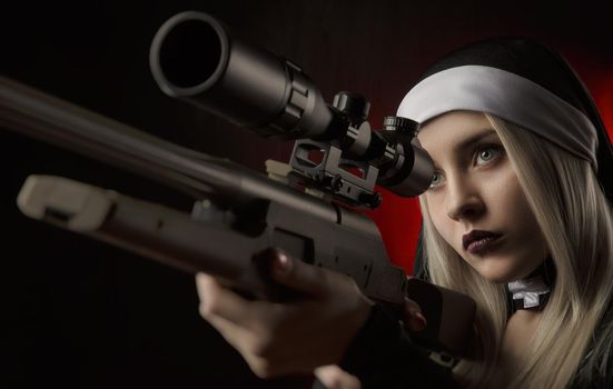 the girl on a black background in a nun dress posing with a gun, aiming, shooting