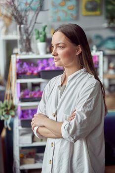 Caucasian female florist is taking care about her plants