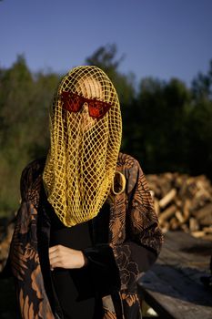 pretty woman wearing sunglasses veil dark background. High quality photo